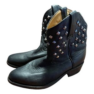 Black, Cowboy Carter looks leather studded, short, cowboy boots.